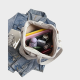 Amalia – Rękawowa torba z detalami ze sznurka